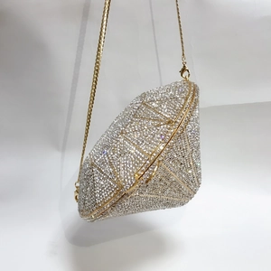 Close-up of geometric diamond-shaped evening bag with full crystal rhinestones and gold chain