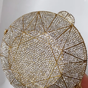 Detailed close-up of a sparkling diamond-shaped evening clutch with crystal inlay