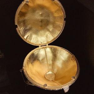 Detailed interior of gold sphere evening clutch with metallic texture and crystal edges