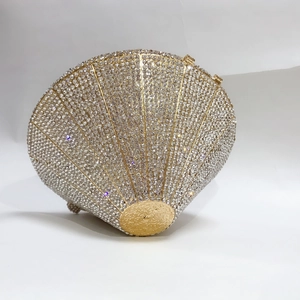 Detailed side view of shell-shaped evening clutch bag with sparkling white rhinestones