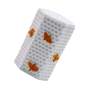 Detailed view of white honeycomb textured mold featuring four small orange decorative bees