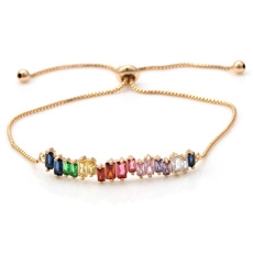 Detail of adjustable gold chain bracelet featuring colorful rainbow rectangular gemstones