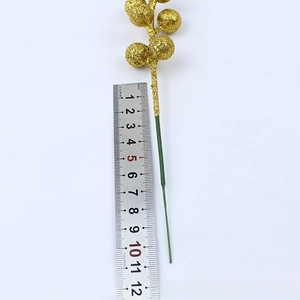 Detailed view of 12cm golden artificial berry spray with ruler showing exact size