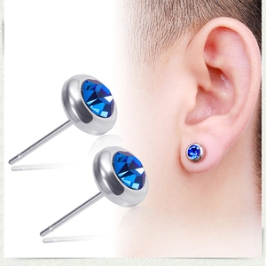 Macro detail of silver stainless steel stud earrings with brilliant blue round crystals