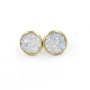 Close-up of 12mm golden stainless steel stud earrings with shimmering white druzy resin inlay