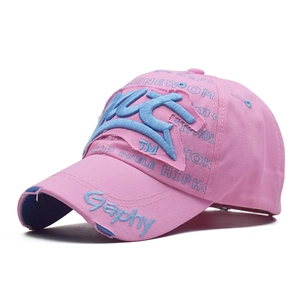 Detail of pink cotton baseball cap featuring blue 3D embroidery and hip-hop prints