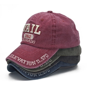 Close-up of four stacked vintage washed cotton baseball caps with 1962 embroidery detail