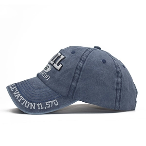 Detailed macro view of vintage washed navy blue cotton baseball cap with 1962 embroidery