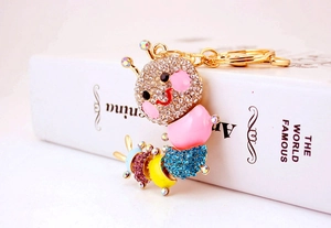 Close-up of colorful rhinestone caterpillar keychain with gold metal plating and enamel
