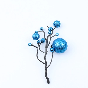 Close-up of blue Christmas berry branches with metallic and glitter finishes for wreaths