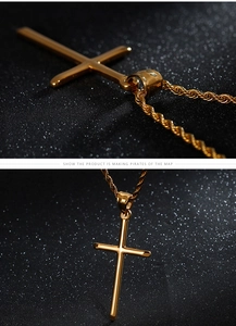 Close-up of golden stainless steel cross pendant necklace with polished finish on black background
