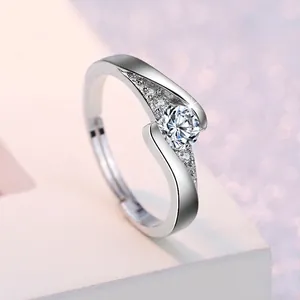Macro shot of silver adjustable ring with a brilliant-cut center stone and paved accents