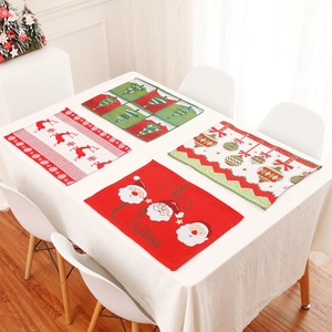 Set of four festive Christmas placemats with reindeer and Santa embroidery for table decor