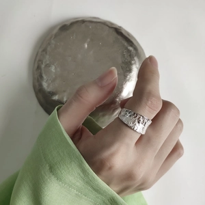 Detail shot of 925 silver ring featuring an irregular lava hammered texture on a hand