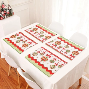 Set of 4 Christmas table mats with red and green chevron patterns and festive ornaments