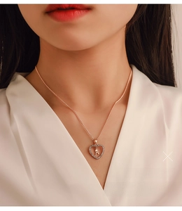 Macro shot of rose gold heart pendant with letter A and shimmering diamonds