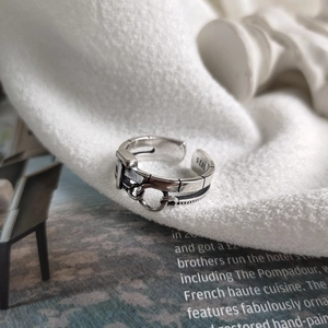 Macro shot of S925 sterling silver ring showing the belt buckle detail and material hallmark