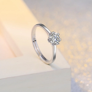 Close-up of a brilliant round-cut zircon ring with romantic heart-shaped six-prong setting