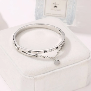 Silver Roman numeral bangle with heart pendant and crystals on elegant jewelry box