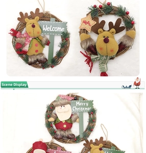 Close-up of Christmas rattan wreath with plush reindeer, Santa and Merry Christmas sign