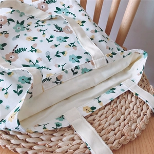 Detail view of floral cotton tote bag with cream straps and soft inner lining