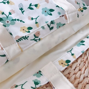 Close-up of the reinforced stitching on a floral canvas tote bag handle attachment