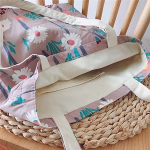Detailed interior view of floral cotton tote bag with open inner pocket and thick handles