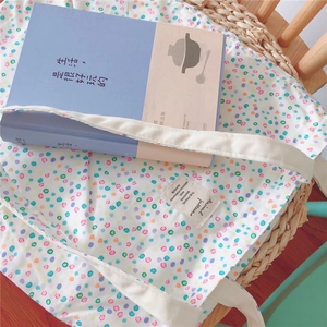 Detailed macro view of the colorful polka dot pattern and fabric label on the canvas tote bag