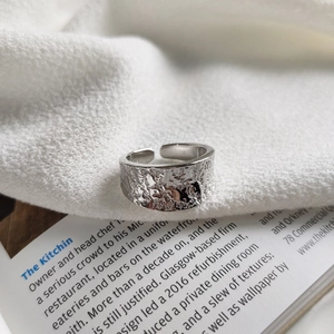 Minimalist 925 silver irregular moon texture open ring on a white fabric background