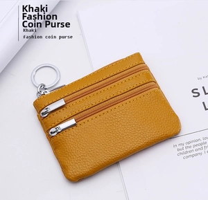 Detail of khaki leather coin purse showing lychee texture, double zippers and key ring