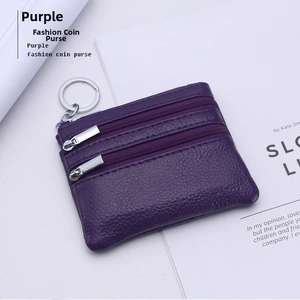 Close-up of deep purple pebble leather coin purse with three zippers and a key ring