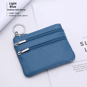 Macro view of light blue lychee pattern leather coin purse with double zipper and key ring