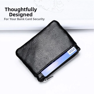Detail of black pebbled leather card holder with card slots and zipper closure