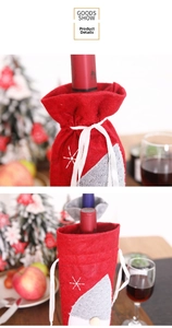 Detail view of red felt Christmas wine bottle cover with white snowflake embroidery and tie