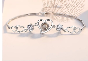 Macro view of 925 sterling silver heart bracelet showing engraving and hallmark details