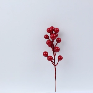 Macro shot of glossy red artificial berry branches for festive Christmas home decoration