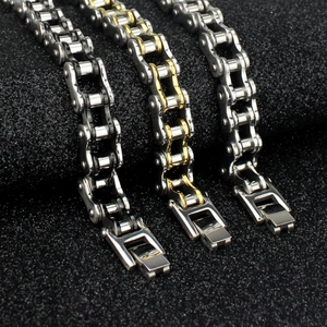 Macro shot of three titanium steel motorcycle chain bracelets in black, gold, and silver