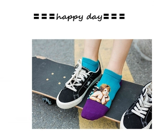 Close-up of blue and purple cotton socks featuring angel prints and ribbed cuffs on a skateboard
