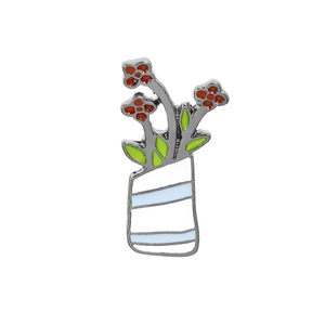 Detailed view of enamel brooch featuring a white striped vase with red flowers and green leaves