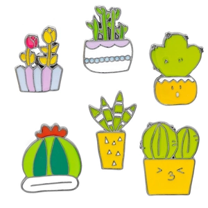 Detail of six colorful cartoon enamel pins featuring various cactus and potted plant designs