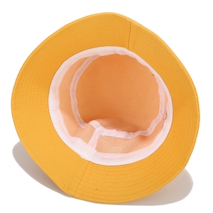 Detail view of cotton bucket hat interior showing white sweatband and clean stitching