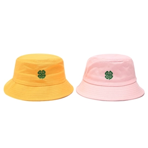 Detailed embroidery of a green clover with H-letter on yellow and pink cotton bucket hats
