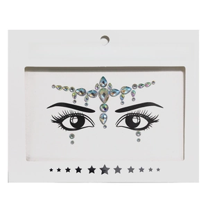 Detailed view of iridescent face crystal stickers on white cardboard packaging