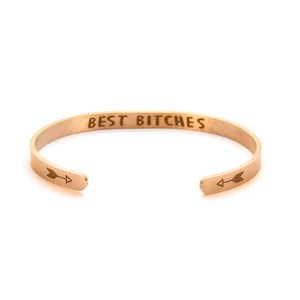 Detail of rose gold titanium steel cuff bracelet with BEST BITCHES engraving