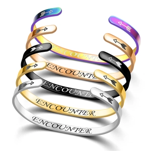 Detail view of adjustable stainless steel cuff bracelets with Encounter engraving