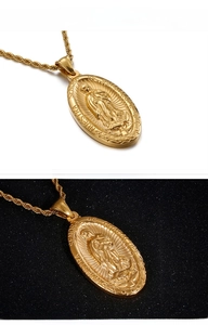 Close-up of golden Our Lady of Guadalupe oval pendant on a twisted rope chain