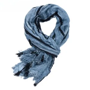 Detailed close-up of blue and black striped scarf with soft fringe edges and lightweight fabric