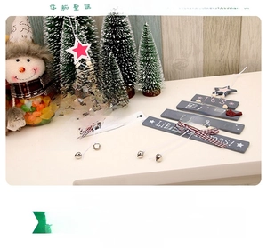 Detailed view of layered wooden Christmas tree hanging ornaments with bells and bows