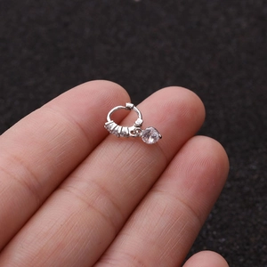 Macro shot of silver micro-pave zircon hoop earring with a round crystal pendant