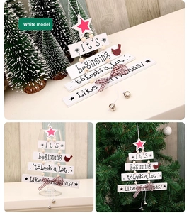 Close-up of white wooden Christmas tree ornament with festive bells and bird detail